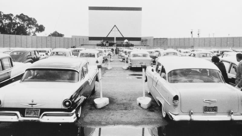 An old photograph of a drive-in movie theater with cars lined up to see the show. By the Everett Collection Inc. Used with "Drive-In Banshees" story.