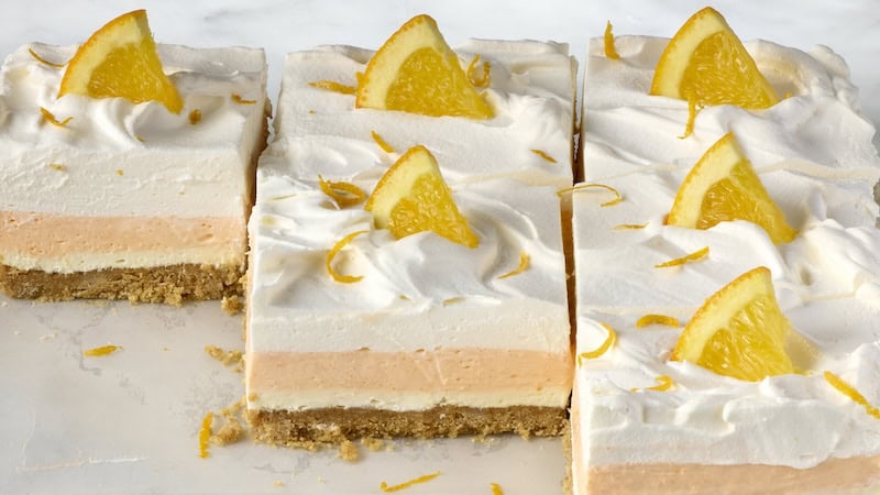 Sideview of cut Orange Creamsicle Dream Bars. These no-bake bars mimic the classic creamsicle flavor.