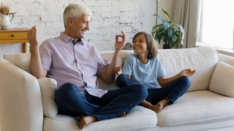 mindfulness meditation: granddad and grandkid enjoying meditation together. By Fizkes