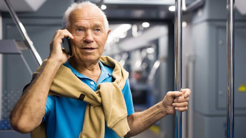 A man talking on his mobile phone on a subway car, risking an overheard conversation. Image by Tatsiana Yatsevich