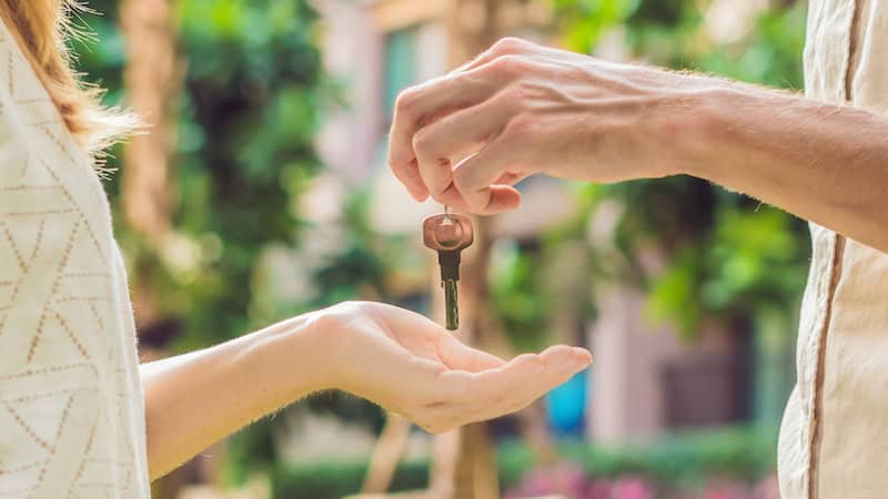 A man returning a key to a woman after she overstepped relationship boundaries