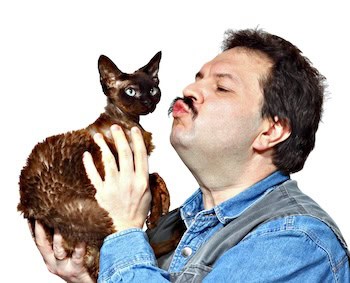 A man giving his kitty a kiss.