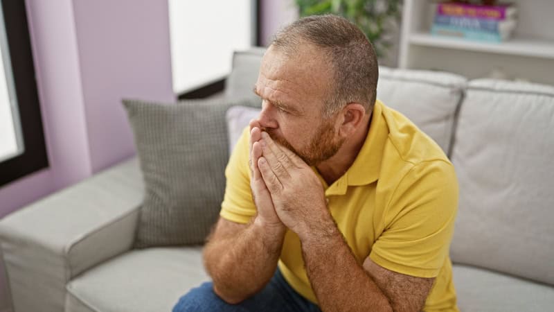 A man experiencing caregiver grief and guilt after his father's death. CREDIT: Aaron Amat