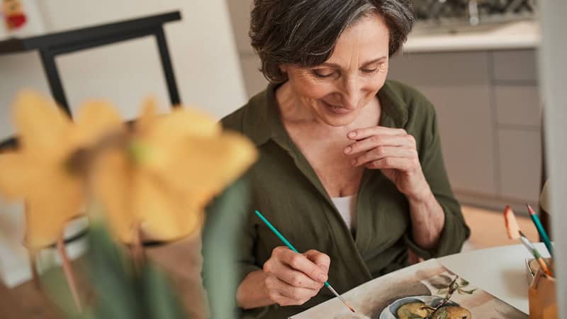 A woman doing watercolor painting, like the woman in this column - a wife craves appreciation and compliments from her husband on her hobbies of watercolor painting and playing a recorder