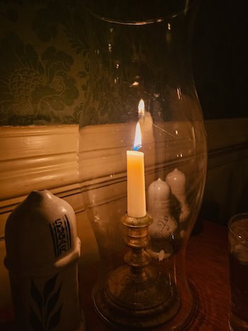 Salt and pepper shakers and candle in King's Arms Tavern, for Williamsburg Area Restaurant Week. Image by Brittany McKibben 