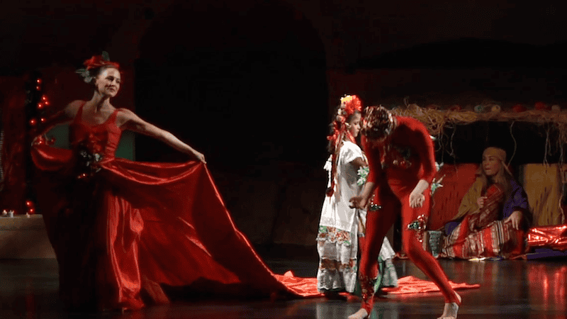 "Legend of the Poinsettia" - screenshot from the Latin Ballet of ballet dancer in red and "poinsettia" rising.