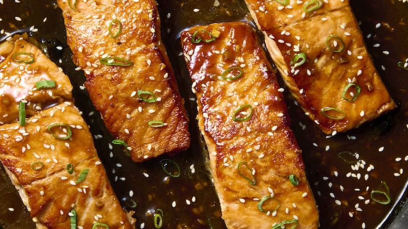 For hoisin glazed salmon: Hoisin sauce and a few pantry ingredients transform into a sticky glaze to baste over the salmon as it cooks. (Alex Lepe/TCA)