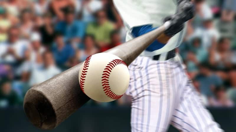 close-up at tip of bat of a baseball player hitting the ball