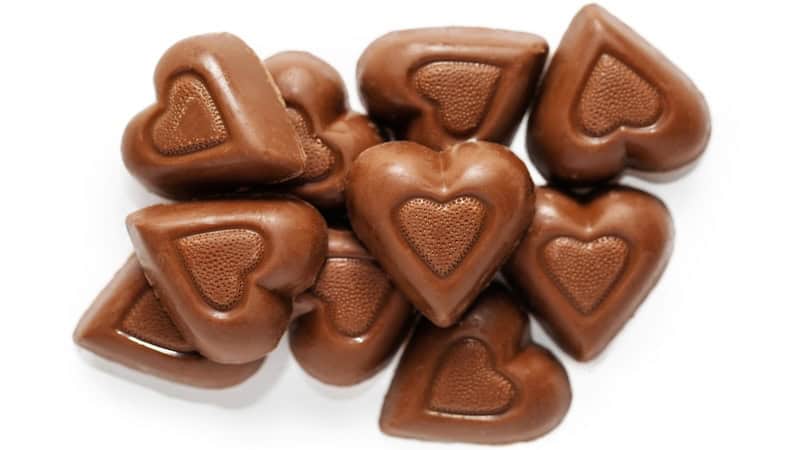 One of the great things about Valentine's Day is chocolate, chocolate and more chocolate. Chocolate hearts on a white background. By adogslifephoto