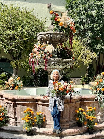 Naomi holding a bouquet upon her return to Mexico and the Instituto Allende